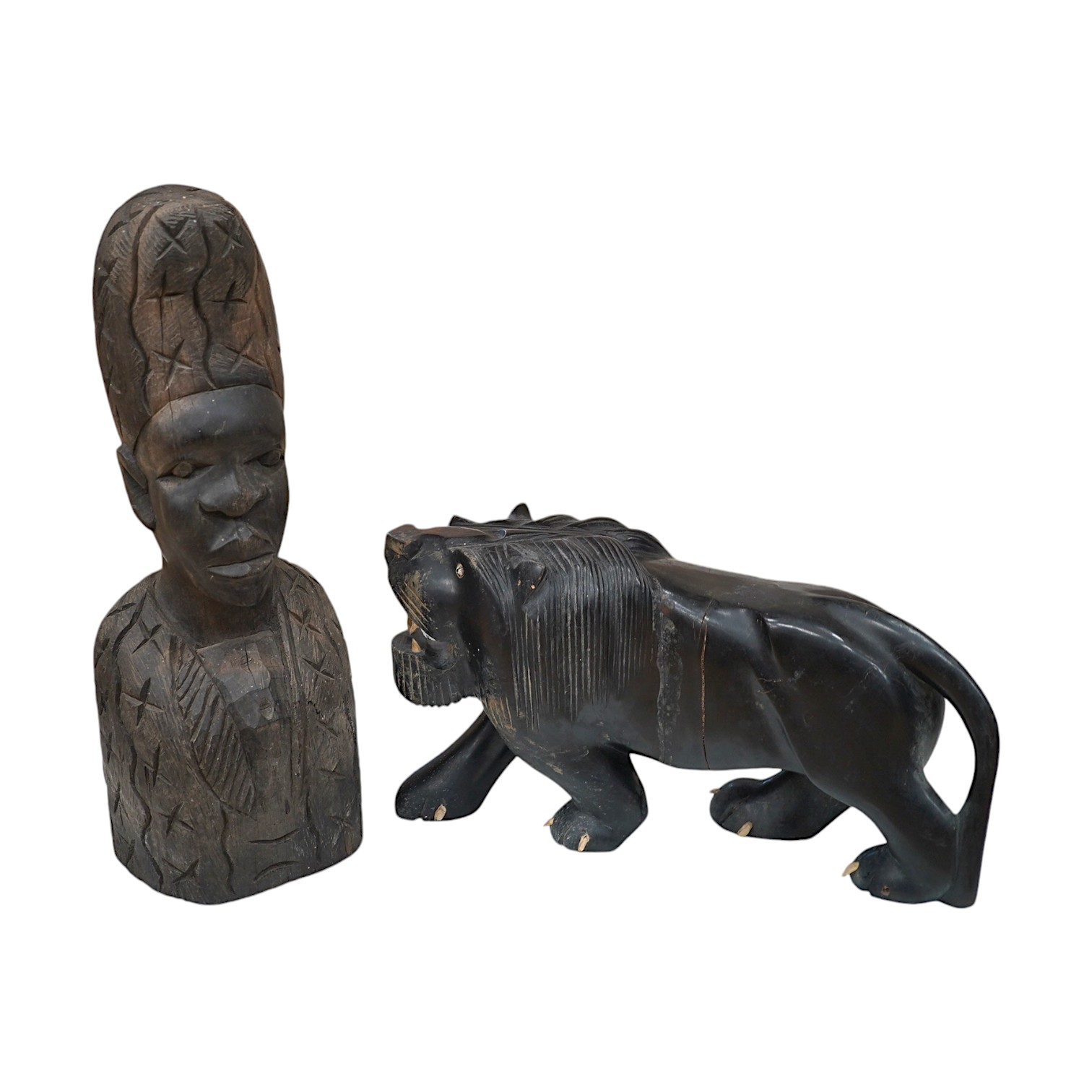 An African hardwood carving of a bust, 41cm high and an ebony Indian carving of a lion, 35cm long, (2). Condition - fair